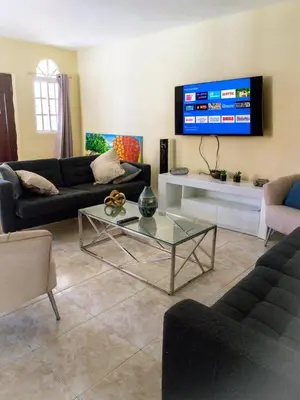 a living room with a couch and a table at The Three Sisters Villa in Puerto Plata