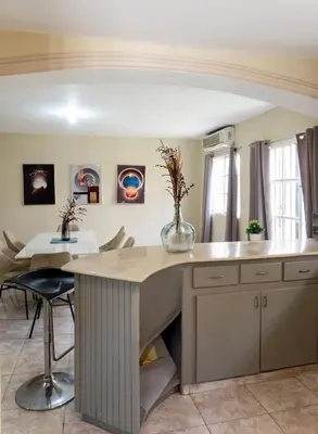 a kitchen with a large island with a table at The Three Sisters Villa in Puerto Plata