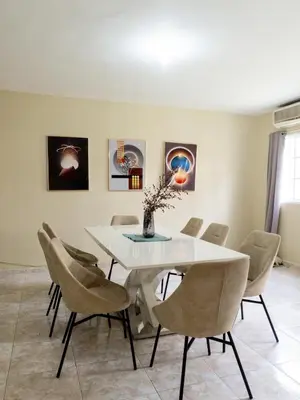a dining room with a white table and chairs at The Three Sisters Villa in Puerto Plata