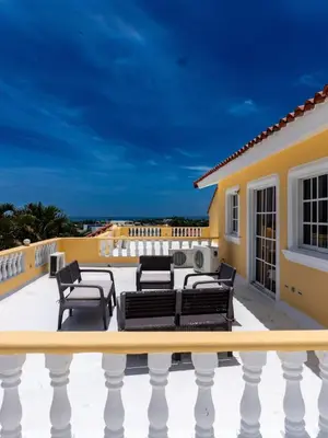 a patio with furniture on the roof of a house at 3BR Villa Newly Renovated-5 min to Playa Dorada H1 in Puerto Plata