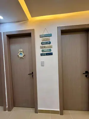 two doors in a building with signs on the wall at Lujoso apartamentos en boca chica in Cuevas