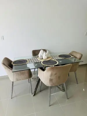 a dining room table with chairs and a glass table at Apartamento muy cerca de la embajada Americana in Santo Domingo