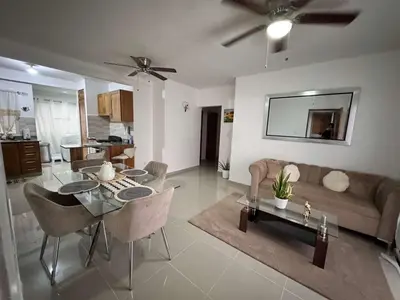 a living room with a table and a couch at Apartamento muy cerca de la embajada Americana in Santo Domingo