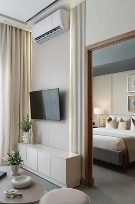 a bedroom with a bed and a tv on a wall at ®{Designer~City~Stay} @DowntownSD NearPark1BR in Santo Domingo