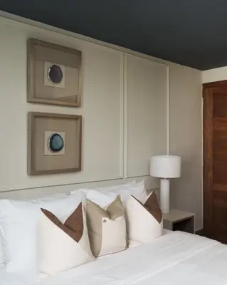 a bedroom with a white bed with white pillows at ®{Designer~City~Stay} @DowntownSD NearPark1BR in Santo Domingo