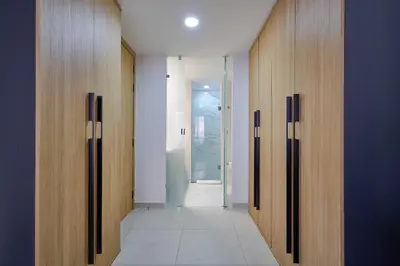 a hallway with wooden doors and a hallway with a hallwayngth at ®2BR{The~City~Center}@DTown PoolGym NearCecilip in Santo Domingo