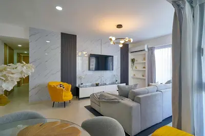 a living room with a couch and a tv at ®2BR{The~City~Center}@DTown PoolGym NearCecilip in Santo Domingo