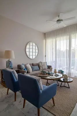 a living room with a couch and a table at {3BR~Beach~Condo}@LakeView PlayaBonita PoolLUX in Las Terrenas
