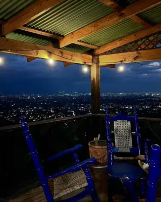 two blue chairs sitting on the edge of a gazebo at Romantic Refuge under the Stars, Villa BellaVista in Tamboril
