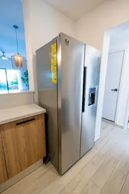 a stainless steel refrigerator in a kitchen with a counter at Suite Boho Swim-Up | Acceso Directo. Playa Privada in Punta Cana