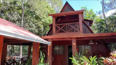 a building with a bird house on top of it at Wooden Paradise in Jarabacoa in Jarabacoa