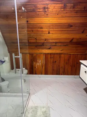 a bathroom with a shower and a toilet at Wooden Paradise in Jarabacoa in Jarabacoa