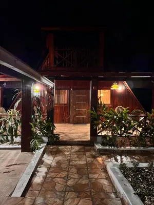 an entrance to a house at night at Wooden Paradise in Jarabacoa in Jarabacoa