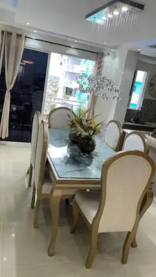 a dining room with a table and chairs and a chandelier at Colinas del arroyo in Santo Domingo