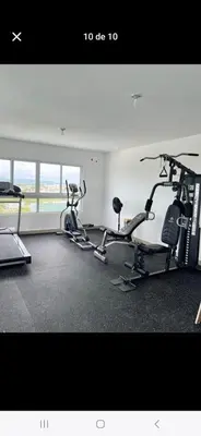 a gym with two treadmills and two exercise bikes at Colinas del arroyo in Santo Domingo