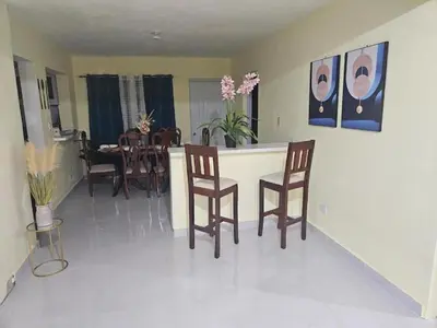 a kitchen and dining room with a table and chairs at Eastern Breeze in Hainamosa