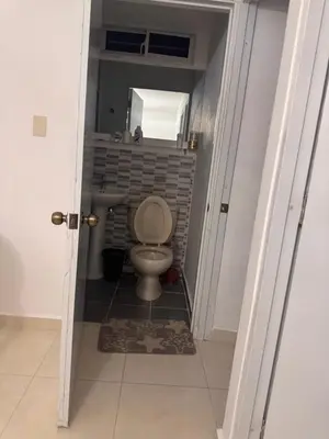 a small bathroom with a toilet and a sink at quality & comfort in Santo Domingo