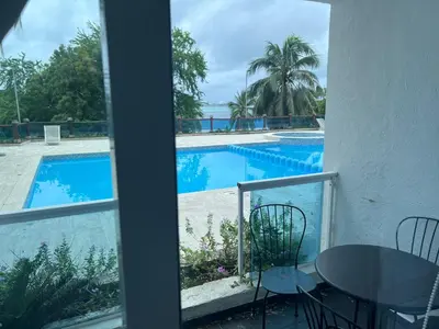 a view of a swimming pool from a balcony at Dreamvillage in Boca Chica