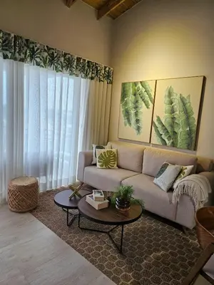 a living room with a couch and a table at Garden Breeze Penthouse & Pool View l Ghibli 401 in La Laguna