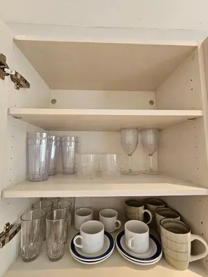 a cupboard filled with glasses and plates and cups at Caribbean Comfort near the Sea l Cefiro 101 in La Laguna
