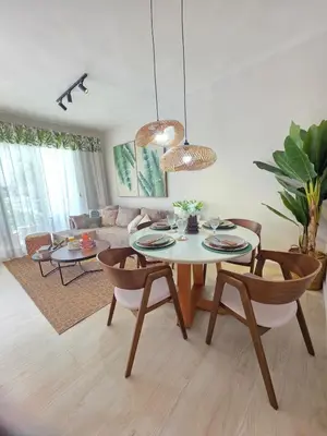 a living room with a table and chairs and a couch at Caribbean Comfort near the Sea l Cefiro 101 in La Laguna