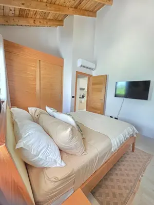 a bedroom with a large bed with white pillows at Garden Breeze Penthouse & Pool View l Mistral 401 in La Laguna