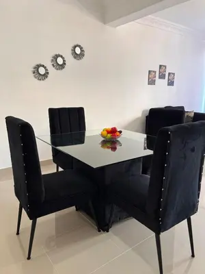 a dining room table and chairs with a bowl of fruit on it at Luxury Royalty-1 in Santa Cruz de Barahona
