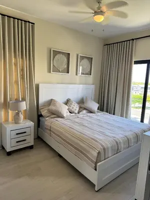 a bedroom with a large bed and a window at Hermoso PUNTA CANA VISTA CANA in Colorado
