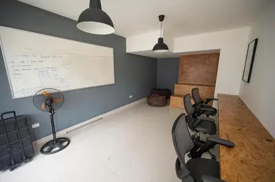a room with a desk and two chairs and a white wall at Santiago s top Residence, Experience it & Believe it in Santiago de los Caballeros