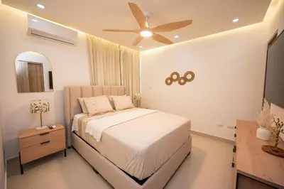 a bedroom with a bed and a ceiling fan at Santiago s top Residence, Experience it & Believe it in Santiago de los Caballeros