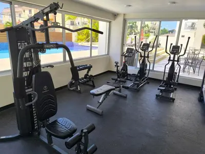 a gym with several tread machines in a room at RIKI R Boca del Mar III Apartment 406 in Boca Chica
