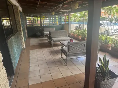 a patio with a couch and a table and chairs at Costa Lunga-Tropicasa in Boca Chica