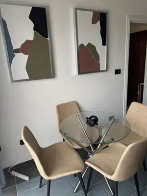 a glass table and two chairs in a room at Costa Lunga-Tropicasa in Boca Chica