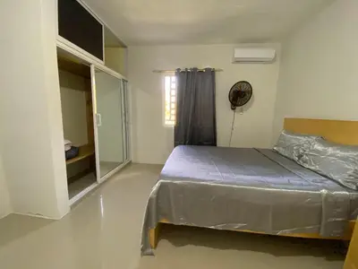 a bedroom with a bed and a window at Casa veraniega en samana in Santa Bárbara de Samaná