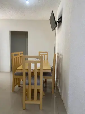 a dining room with a wooden table and chairs at Casa veraniega en samana in Santa Bárbara de Samaná