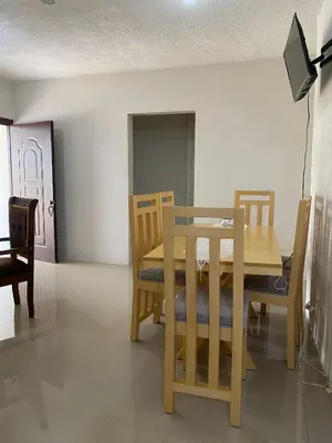a dining room with a wooden table and chairs at Casa veraniega en samana in Santa Bárbara de Samaná