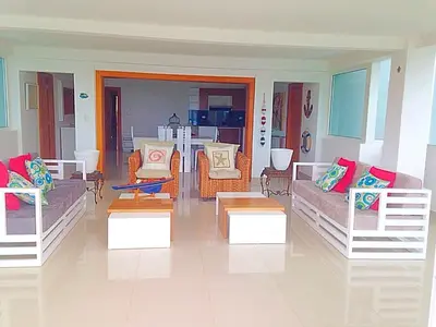 a living room with couches and tables in it at Vista Marina Residence in Boca Chica