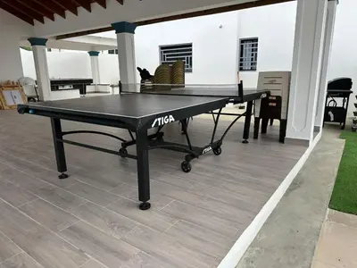 a ping pong table sitting on top of a patio at Residencial HH in Santiago de los Caballeros