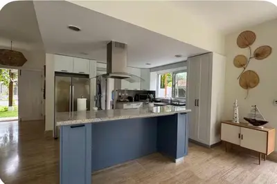 a kitchen with a blue island in a room at Portillo Beach Family House in El Limón