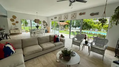 a living room with a couch and a table at Portillo Beach Family House in El Limón