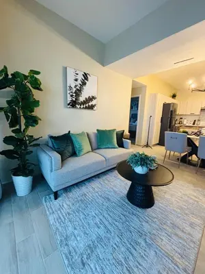 a living room with a couch and a table at Apartment Punta Cana Oasis ONA Residences in Punta Cana
