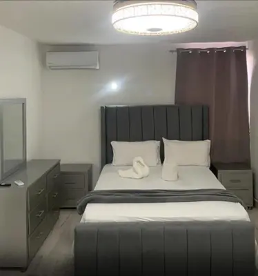 a bedroom with a large bed with white pillows at El Legendario in Sosúa