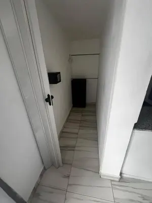 an empty room with a hallway with a white door at El Legendario in Sosúa