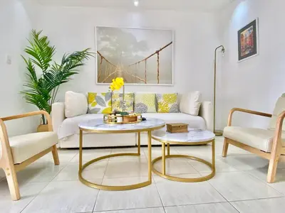 a living room with a couch and two chairs at Stylish 3BR Condo, Full AC, Wi-Fi in Santo Domingo