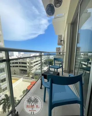 a balcony with two chairs and a view of a building at Boca del Mar III Apartment 724 in Boca Chica
