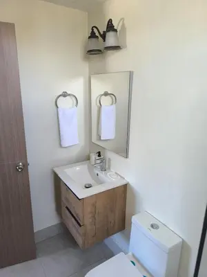 a bathroom with a sink and a mirror and a toilet at Boca del Mar III Apartment 724 in Boca Chica