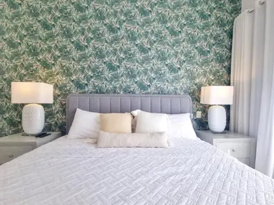 a bedroom with a bed with two lamps on tables at Aqua Pearl ! Pool Access 2 BRM J 102 in Punta Cana