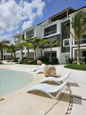 a villa with a swimming pool and two lounge chairs at Estrella Garden Condos Dominicus l Meridiana 204 in La Laguna