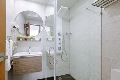 a bathroom with a shower and a sink and a mirror at Upscale City Center Condo Pool in Santo Domingo