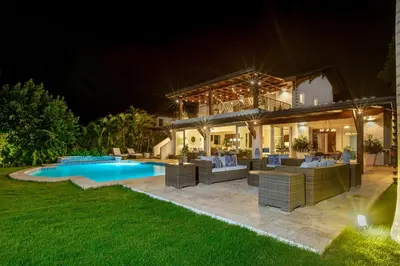 a villa with a swimming pool at night at Villa Polo Luxury Villa in Casa de Campo, La Romana in La Romana